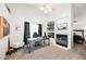 Inviting home office space with fireplace, desk, chair, and ample natural light at 841 Glitter Glen Ct, Las Vegas, NV 89123