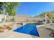 Sparkling pool with steps, elegant planters, and outdoor seating under a bright blue sky at 841 Glitter Glen Ct, Las Vegas, NV 89123