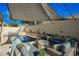 Inviting pool area with stylish outdoor lounge furniture, and shade canopy at 841 Glitter Glen Ct, Las Vegas, NV 89123