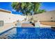 Beautiful backyard featuring a private pool, hot tub, and lounging area for relaxation and entertainment at 841 Glitter Glen Ct, Las Vegas, NV 89123