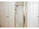 Bright bathroom with white tile shower with a glass enclosure between two linen closets at 841 Glitter Glen Ct, Las Vegas, NV 89123