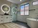 Modern bathroom featuring a glass shower, soaking tub, and stylish vanity at 9272 W Viking Rd, Las Vegas, NV 89147