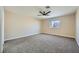 Large carpeted bedroom with ceiling fan and three windows at 9272 W Viking Rd, Las Vegas, NV 89147