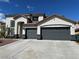 Charming two-story home featuring a spacious three-car garage and desert landscaping in front yard at 9272 W Viking Rd, Las Vegas, NV 89147
