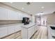 Modern kitchen featuring a large island, marble countertops, stainless steel appliances, and hardwood floors at 9272 W Viking Rd, Las Vegas, NV 89147