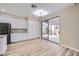 Modern kitchen features a sliding glass door to patio, white cabinetry, and hardwood floors at 9272 W Viking Rd, Las Vegas, NV 89147