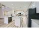Bright kitchen featuring a large island, marble countertops, stainless steel appliances, and hardwood floors at 9272 W Viking Rd, Las Vegas, NV 89147
