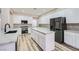 Gourmet kitchen boasts marble countertops, white cabinetry, stainless steel appliances, and kitchen island at 9272 W Viking Rd, Las Vegas, NV 89147