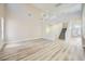 Open floor plan living room with luxury vinyl plank flooring and staircase to the second level at 9272 W Viking Rd, Las Vegas, NV 89147