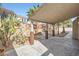 Spacious covered patio with stone flooring and decorative features including a rock waterfall and garden at 9272 W Viking Rd, Las Vegas, NV 89147