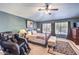 Spacious bedroom featuring a comfortable bed, massage chair, and ample natural light at 9378 Chateau St Jean Dr, Las Vegas, NV 89123