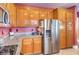 Traditional kitchen with stainless steel appliances, granite countertops, and wooden cabinets at 9378 Chateau St Jean Dr, Las Vegas, NV 89123