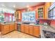 Efficient kitchen with granite counters, wood cabinets, stainless appliances, and tile floors at 9378 Chateau St Jean Dr, Las Vegas, NV 89123