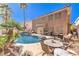 Pool with patio, lounge chairs, outdoor table and chairs and desert landscaping at 9378 Chateau St Jean Dr, Las Vegas, NV 89123