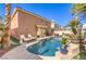 The backyard features a lovely pool, patio and lush landscaping at 9378 Chateau St Jean Dr, Las Vegas, NV 89123
