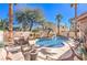 A gorgeous backyard featuring a pool, lounge chairs, palm trees and desert landscaping at 9378 Chateau St Jean Dr, Las Vegas, NV 89123