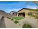 This backyard features a putting green, gravel landscaping, and a covered patio, perfect for outdoor relaxation at 97 Sarabeth St, Las Vegas, NV 89138