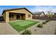 This backyard features a putting green, gravel landscaping, and a covered patio, perfect for outdoor enjoyment at 97 Sarabeth St, Las Vegas, NV 89138