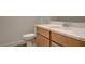 Well-lit bathroom with a toilet, a sink with modern fixtures, and a cabinet providing storage at 97 Sarabeth St, Las Vegas, NV 89138