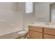 A well-lit bathroom featuring a shower-tub combo, modern sink vanity, and neutral tones for a clean aesthetic at 97 Sarabeth St, Las Vegas, NV 89138