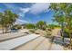 Beautifully landscaped community park with walking paths and shaded seating areas and flowering trees at 97 Sarabeth St, Las Vegas, NV 89138