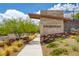 A stone community sign marks the entrance, complemented by desert landscaping and a walkway at 97 Sarabeth St, Las Vegas, NV 89138