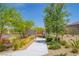 The inviting community entrance boasts lush landscaping and a paved walkway, creating a welcoming first impression at 97 Sarabeth St, Las Vegas, NV 89138