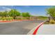 Well-maintained community entrance with lush landscaping and clearly marked lanes, ensures a secure entry at 97 Sarabeth St, Las Vegas, NV 89138