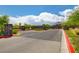 An inviting entrance to a community featuring well maintained landscaping, and a mountain in the distance at 97 Sarabeth St, Las Vegas, NV 89138