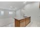 Kitchen view showing granite island with sink, leading to a carpeted living space at 97 Sarabeth St, Las Vegas, NV 89138