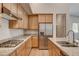 Modern kitchen with granite countertops, stainless steel appliances and wooden cabinets at 97 Sarabeth St, Las Vegas, NV 89138