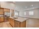 Open concept kitchen features an island with granite countertop, stainless appliances, and wood flooring at 97 Sarabeth St, Las Vegas, NV 89138
