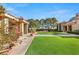 This luxury backyard features manicured landscaping, covered lanais, and immaculate artificial turf at 9940 Orient Express Ct, Las Vegas, NV 89145