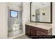 The upstairs bathroom offers a tiled shower with glass doors and a dark wood cabinet at 9940 Orient Express Ct, Las Vegas, NV 89145