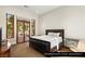 Downstairs guest bedroom featuring a queen bed and access to the outdoor patio at 9940 Orient Express Ct, Las Vegas, NV 89145