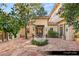Charming courtyard with a decorative well, mature trees, and tiled flooring at 9940 Orient Express Ct, Las Vegas, NV 89145