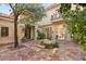 Picturesque courtyard featuring a well, mature trees and stone archway at 9940 Orient Express Ct, Las Vegas, NV 89145