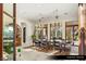 Formal dining room with a large wooden table and decorative chandeliers at 9940 Orient Express Ct, Las Vegas, NV 89145
