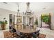 Bright dining room with french doors, large table, and decorative lighting at 9940 Orient Express Ct, Las Vegas, NV 89145