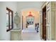 Bright entry foyer with a red chandelier, arched doorways, and stone flooring at 9940 Orient Express Ct, Las Vegas, NV 89145