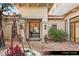 Elegant entryway with an iron door, stone pavers, and decorative planters at 9940 Orient Express Ct, Las Vegas, NV 89145
