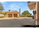 A spacious two-car garage with a wide paved driveway and manicured landscaping at 9940 Orient Express Ct, Las Vegas, NV 89145