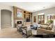 Cozy Gathering room with fireplace, built-in shelving, and comfortable seating arrangement at 9940 Orient Express Ct, Las Vegas, NV 89145
