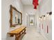 Bright hallway featuring neutral walls, unique light fixtures, and a decorative console table at 9940 Orient Express Ct, Las Vegas, NV 89145