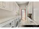 Spacious laundry room with modern machines, ample storage, and bright natural light at 9940 Orient Express Ct, Las Vegas, NV 89145
