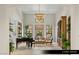 Elegant living room with high ceilings, piano, and many windows at 9940 Orient Express Ct, Las Vegas, NV 89145