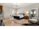 Spacious primary bedroom with hardwood floors, luxury bed, bedside tables, and a sitting area at 9940 Orient Express Ct, Las Vegas, NV 89145
