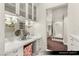 Bright makeup vanity featuring marble countertops, wall sconces, and lots of cabinet space at 9940 Orient Express Ct, Las Vegas, NV 89145