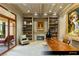 Comfortable office featuring bookshelves, a fireplace, and a live edge desk at 9940 Orient Express Ct, Las Vegas, NV 89145
