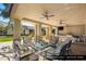 A covered outdoor kitchen and seating area is furnished with luxury seating and appliances at 9940 Orient Express Ct, Las Vegas, NV 89145